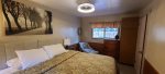 Master bedroom has a king bed with a window viewing the beautiful woods nearby.